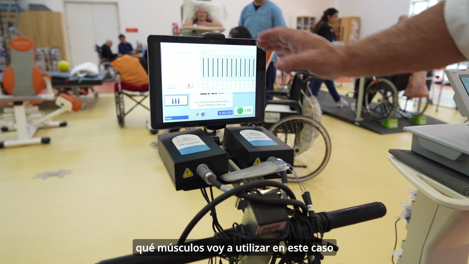 Clinician presenting the RT300 stimulation and cycling system